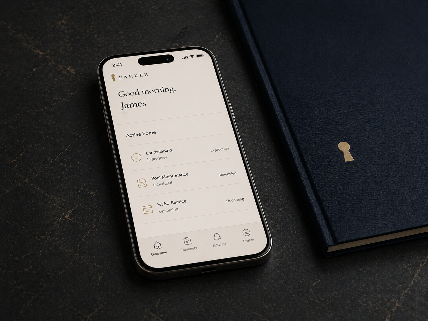 Parker portal on phone resting on a navy leather folio with an embossed gold keyhole