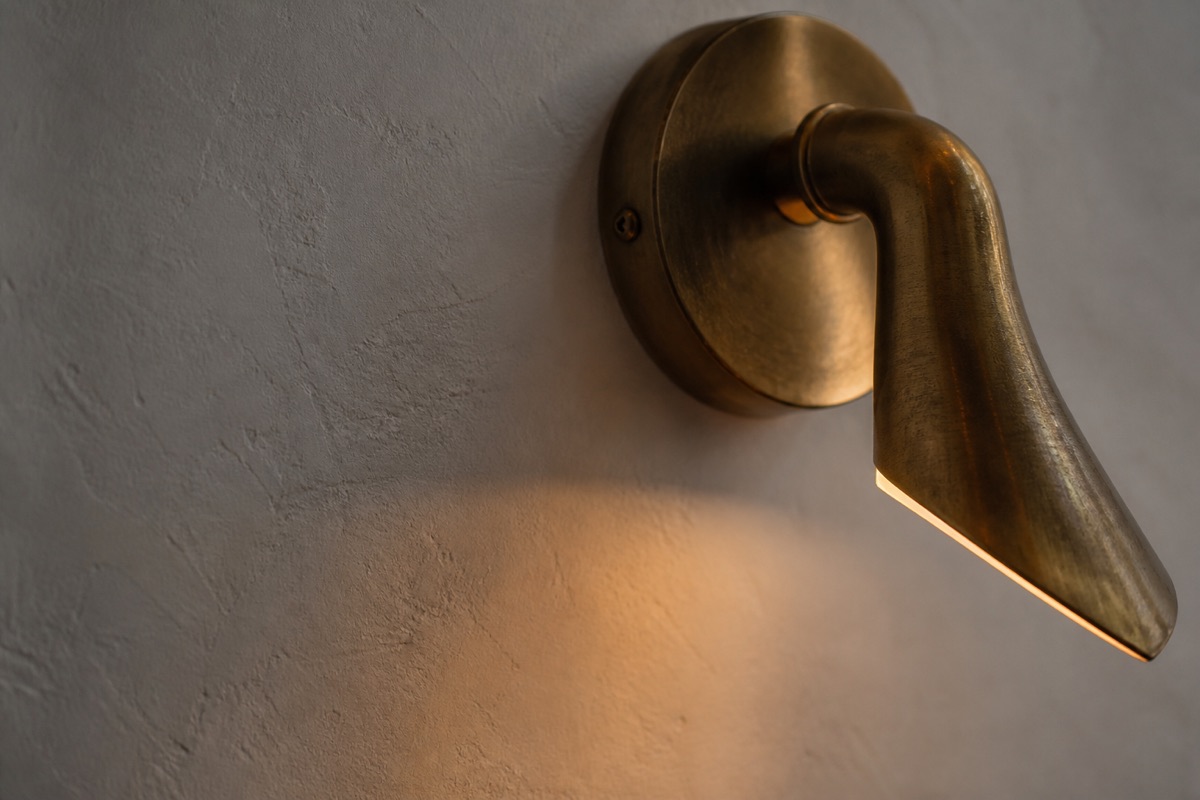 A warm light fixture against plaster